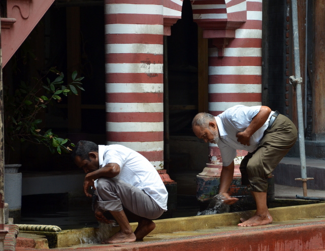 Photo: Worshiper washing their feet at the Jami-Ul-Alfar Mosque in the Pettah neighborhood of Colombo, Sri Lanka